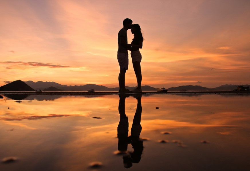 A couple standing on the beach
