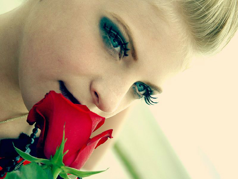woman smelling rose