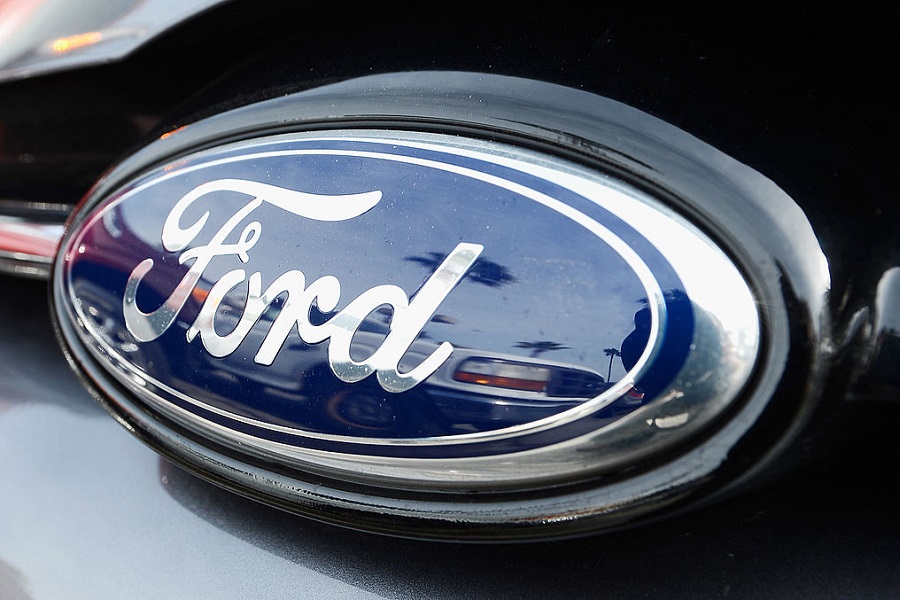 The Ford logo on a car is seen at a dealership