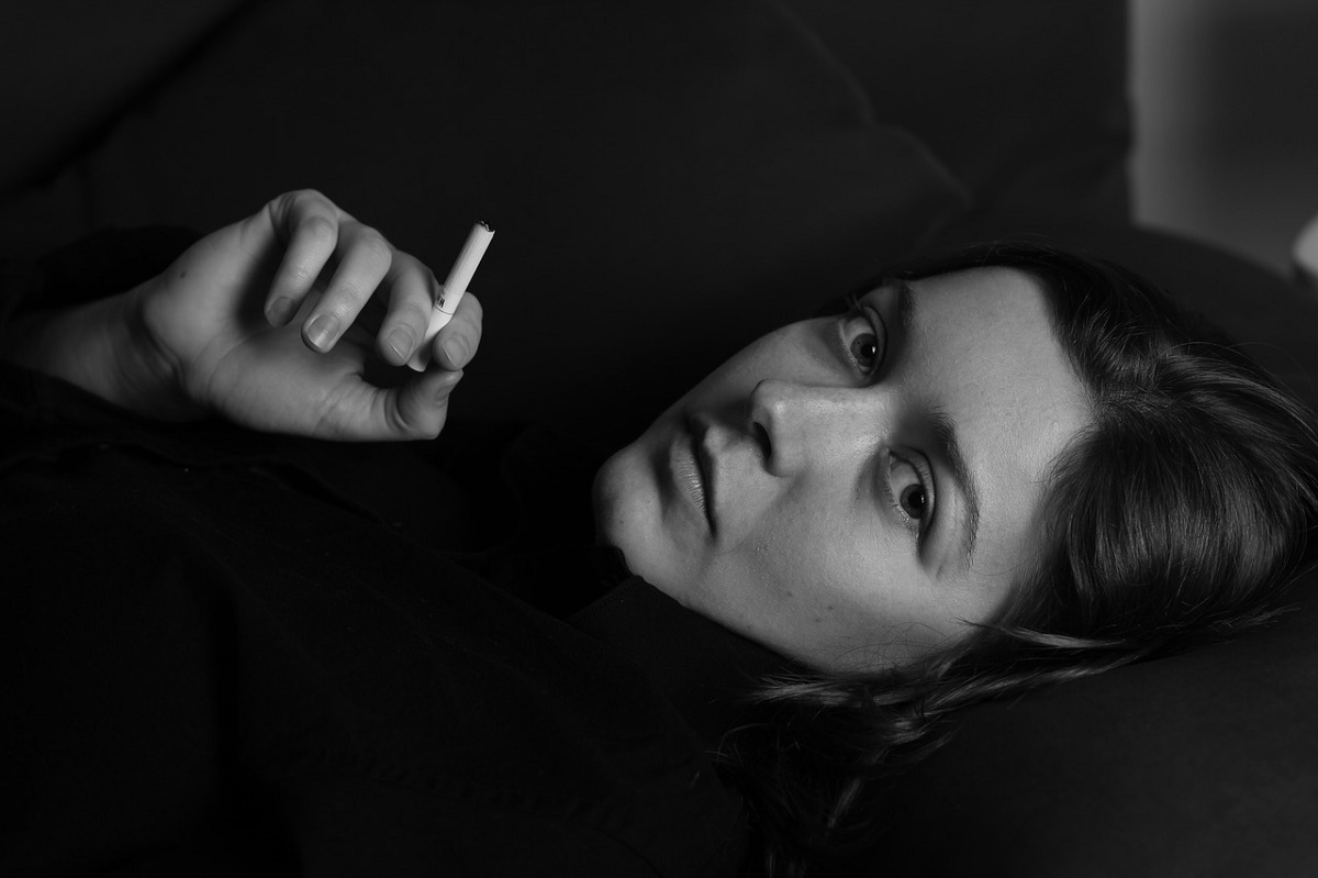 Woman Lying Down and Smoking