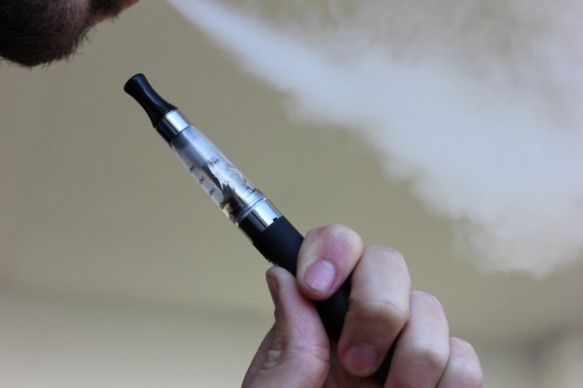 Man vaping an e-cigarette