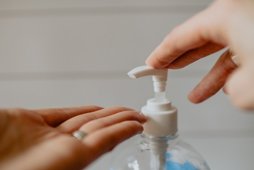 Cleaning hands with hand sanitizer