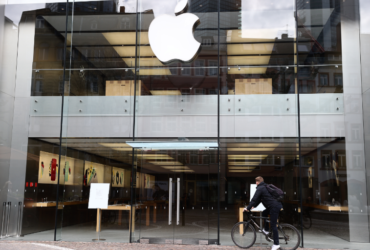 A man stands in front of a closed Apple store during the spread of the coronavirus disease (COVID-19) in Frankfurt