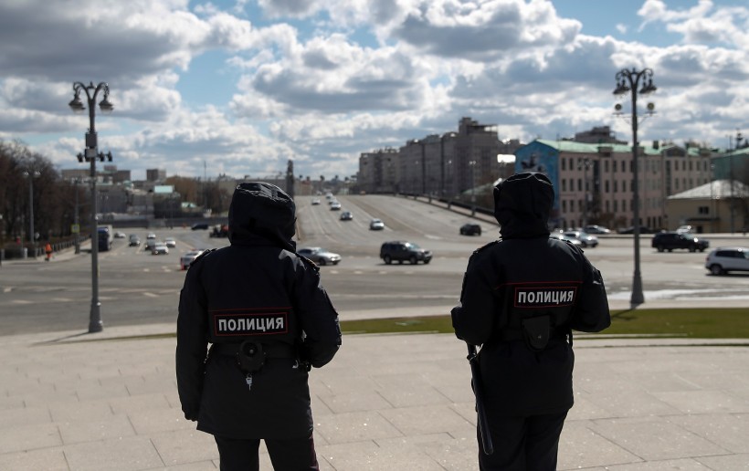 Police officers stand guard while patrolling streets amid the coronavirus disease outbreak in central Moscow