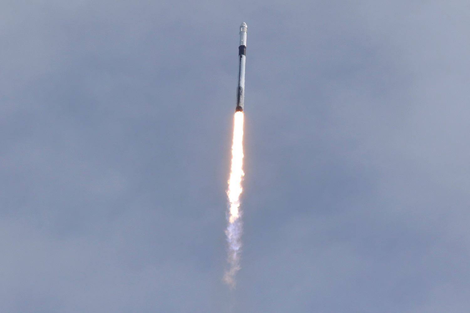A SpaceX Falcon 9 rocket, carrying the Crew Dragon astronaut capsule, lifts off on an in-flight abort test from the Kennedy Space Center in Cape Canaveral