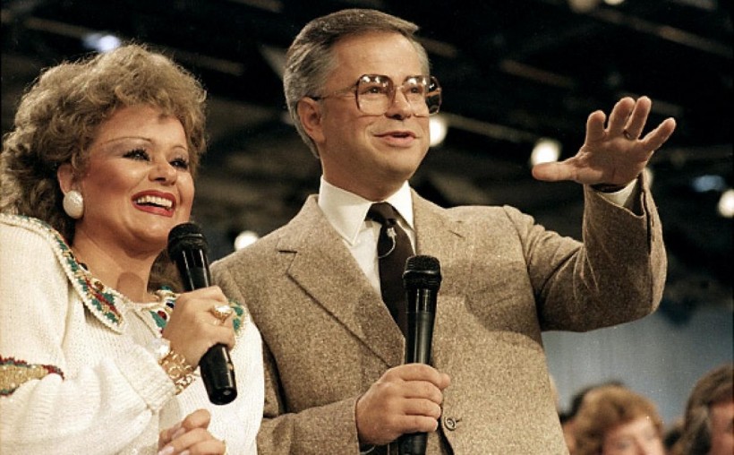 Jim Bakker during a PTL broadcast with his wife Tammy Faye, 1986.