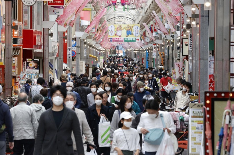 People make their way in a shopping street in Tokyo