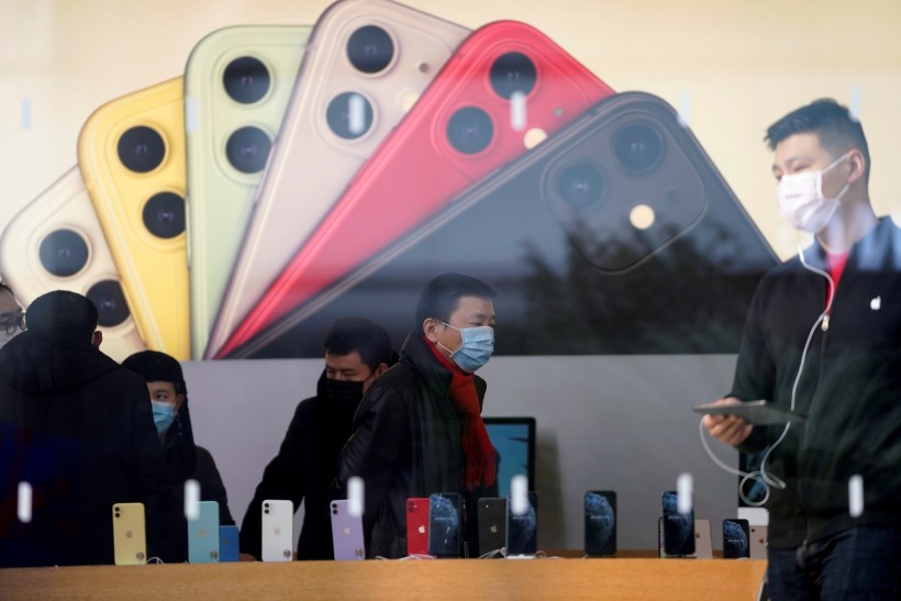 People wearing protective masks are seen in an Apple Store in Shanghai