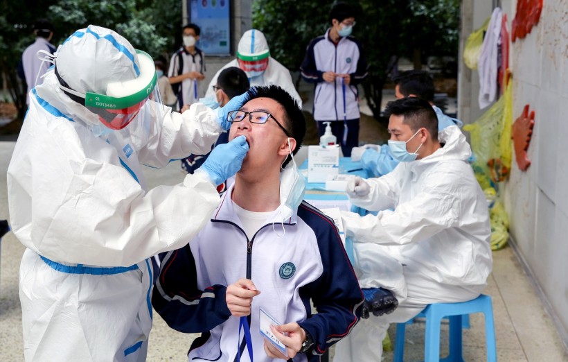 Workers collect swabs from senior high school students for nucleic acid tests in Wuhan