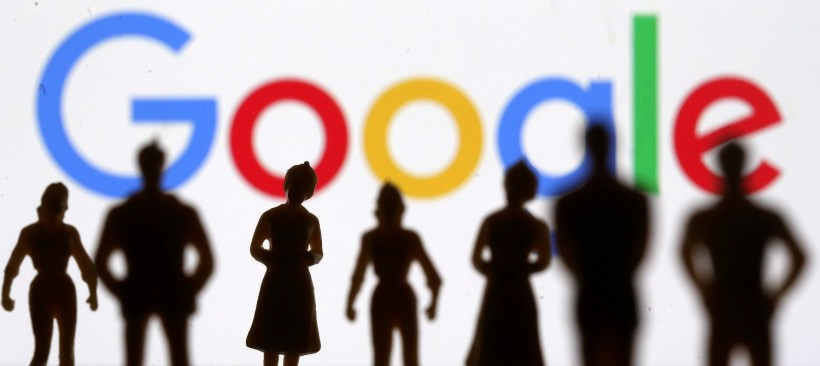 Small toy figures are seen in front of Google logo in this illustration picture