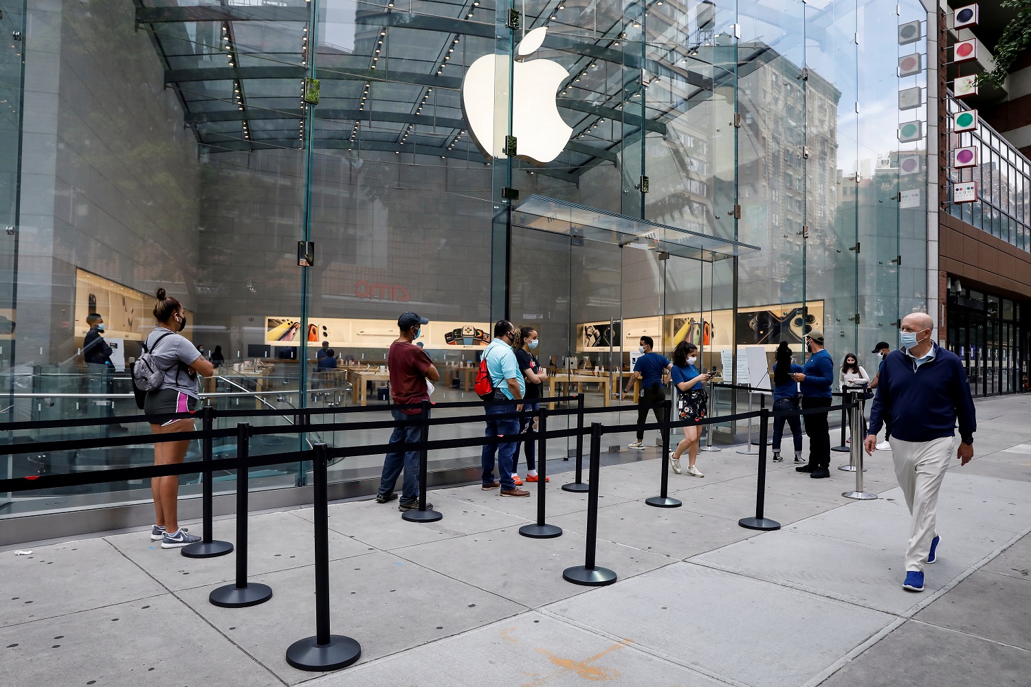 Customers distance before entering an Apple Store during phase one of reopening after COVID-19 lockdown in New York City