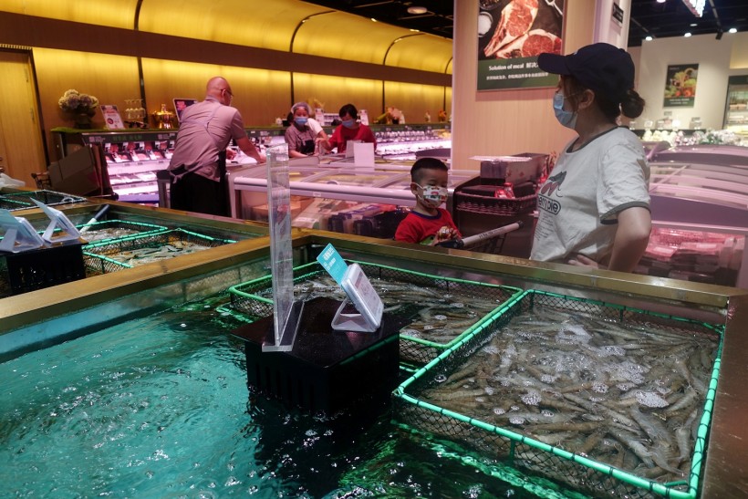 Customers are seen at a live seafood section inside a supermarket, following a new outbreak of the coronavirus disease (COVID-19), in Beijing