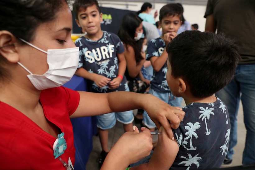 A child receives a vaccination as part of the start of the seasonal flu vaccination campaign as a preventive measure due to the outbreak of coronavirus disease (COVID-19)