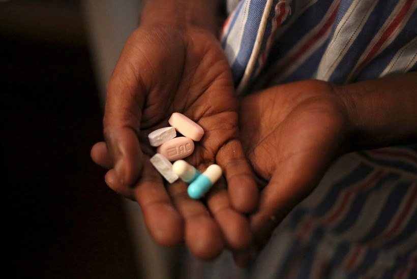 Nine-year-old Tumelo shows off antiretroviral (ARV) pills before taking his medication at Nkosi's Haven, south of Johannesburg