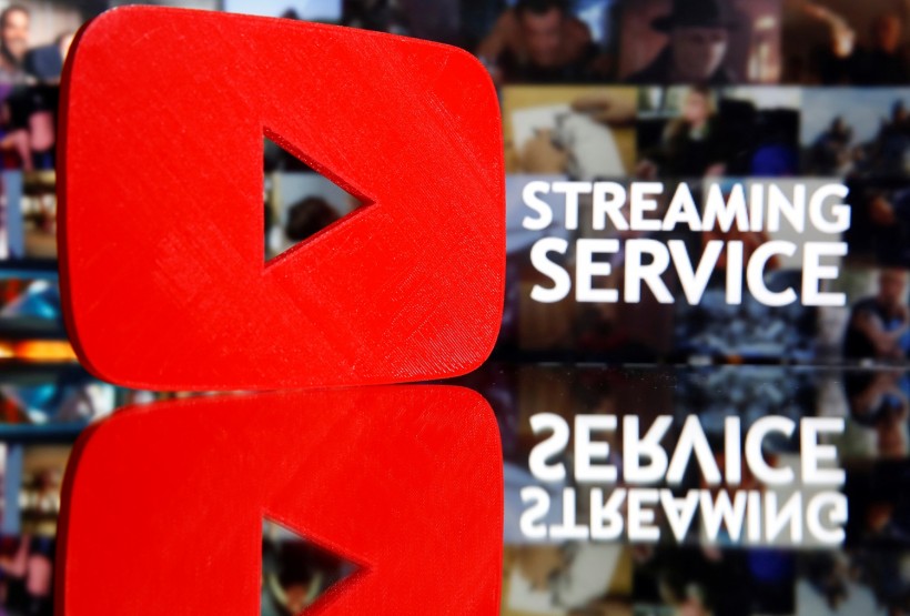 A 3D-printed Youtube logo is seen in front of displayed 