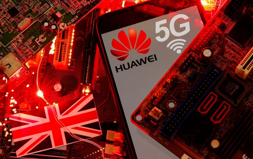 The British flag and a smartphone with a Huawei and 5G network logo are seen on a PC motherboard in this illustration
