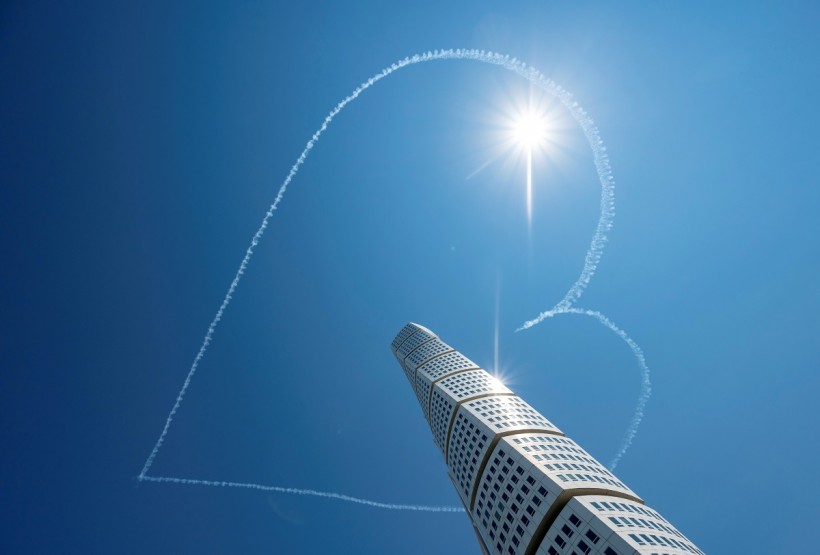 Airplanes of the Scandinavian Airshow draw a heart in the sky, above the Turning Torso building, amid the spread of the coronavirus disease (COVID-19), in Malmo