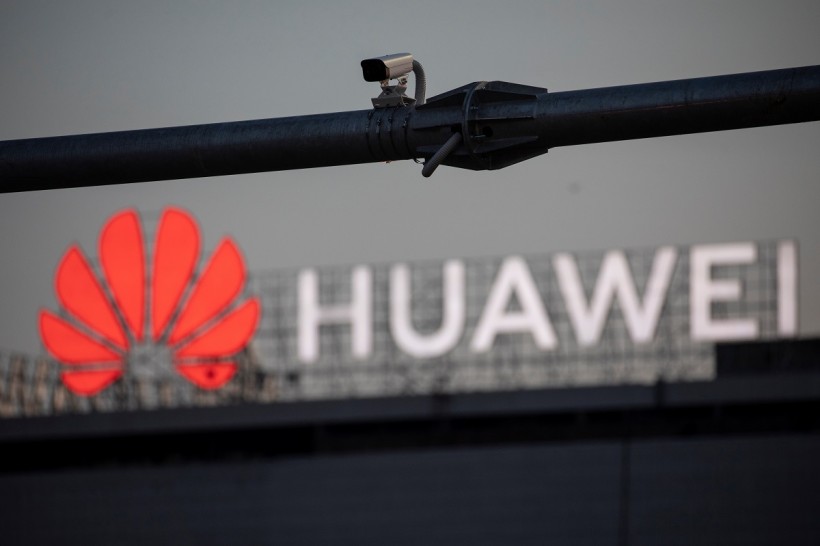A surveillance camera is seen in front of a Huawei logo, in Belgrade