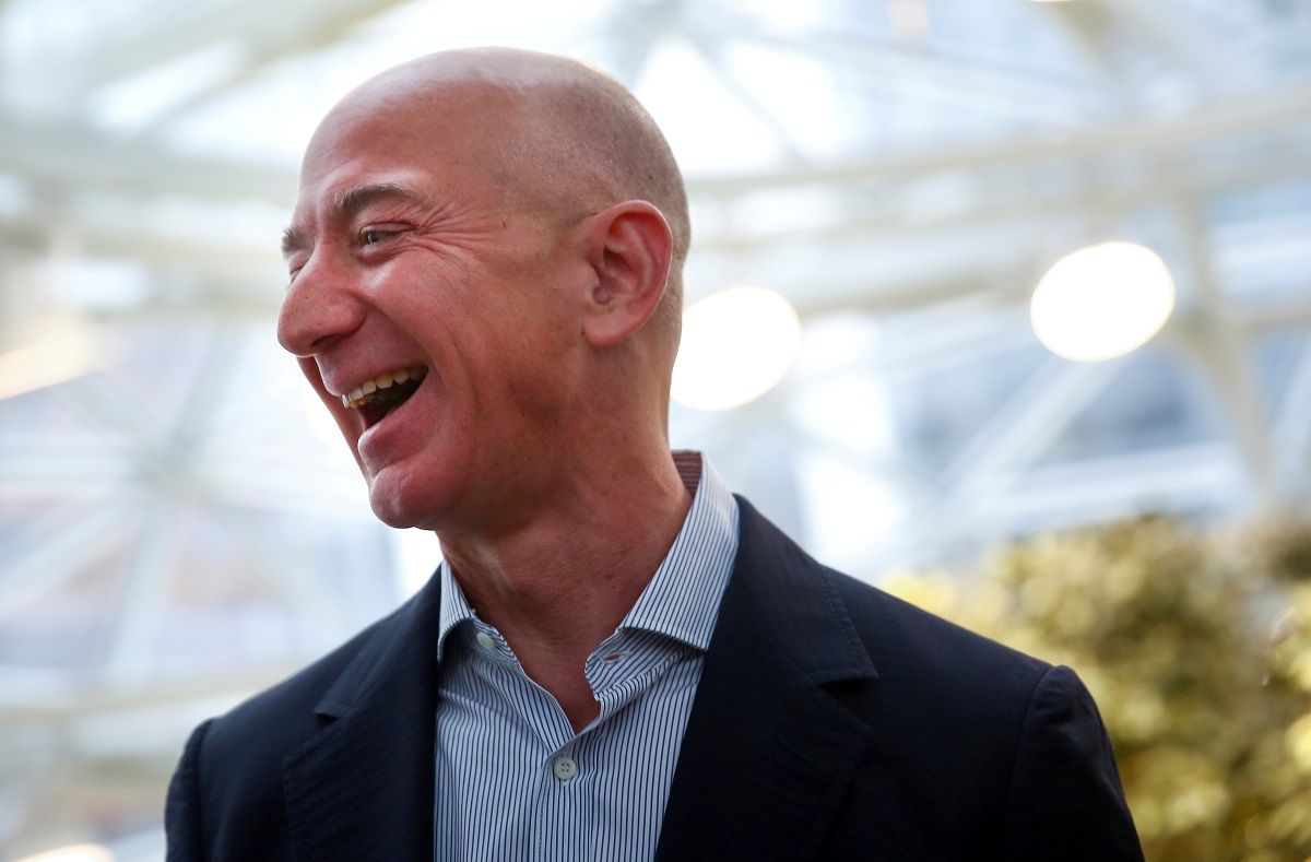 Amazon founder and CEO Jeff Bezos laughs as he talks to the media while touring the new Amazon Spheres during the grand opening in Seattle