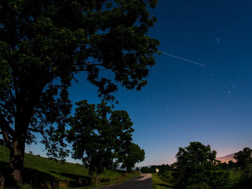 The International Space Station is seen in this 30 second exposure as it flies over Elkton, VA early in the morning, Saturday, August 1, 2015. 
