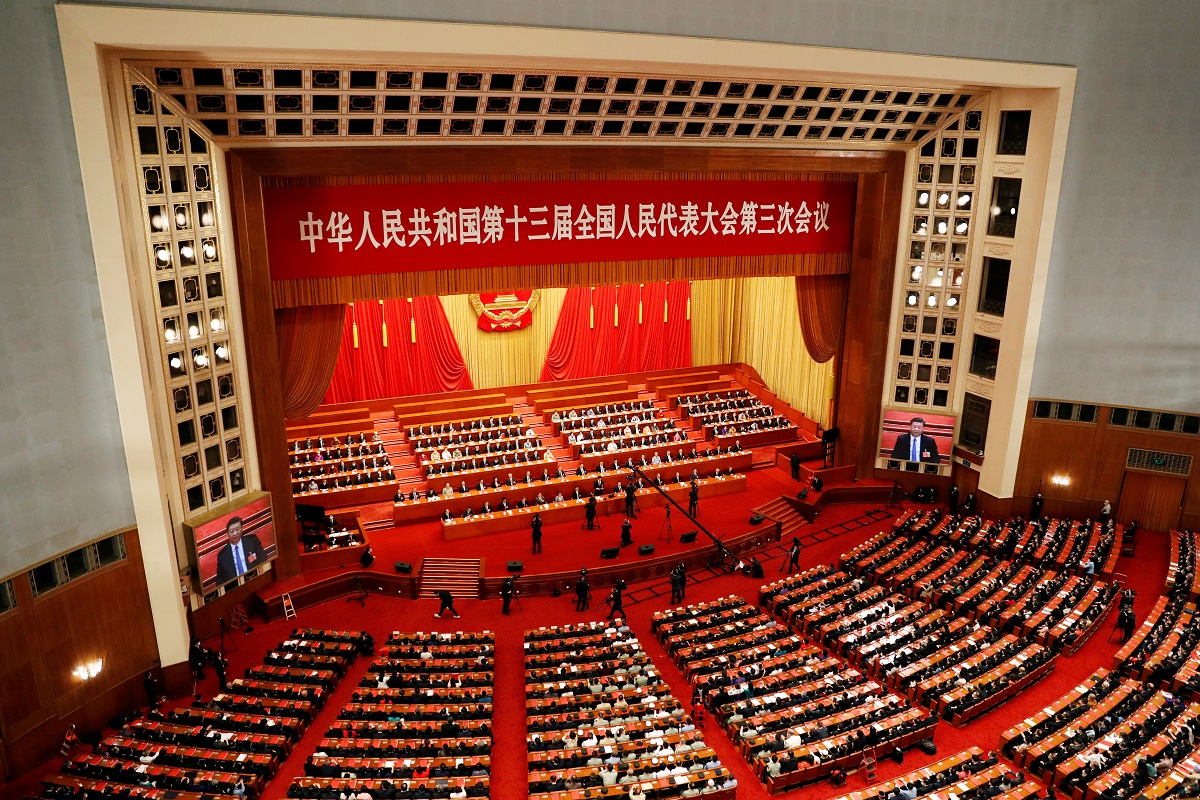 Chinese officials and delegates attend the closing session of NPC in Beijing