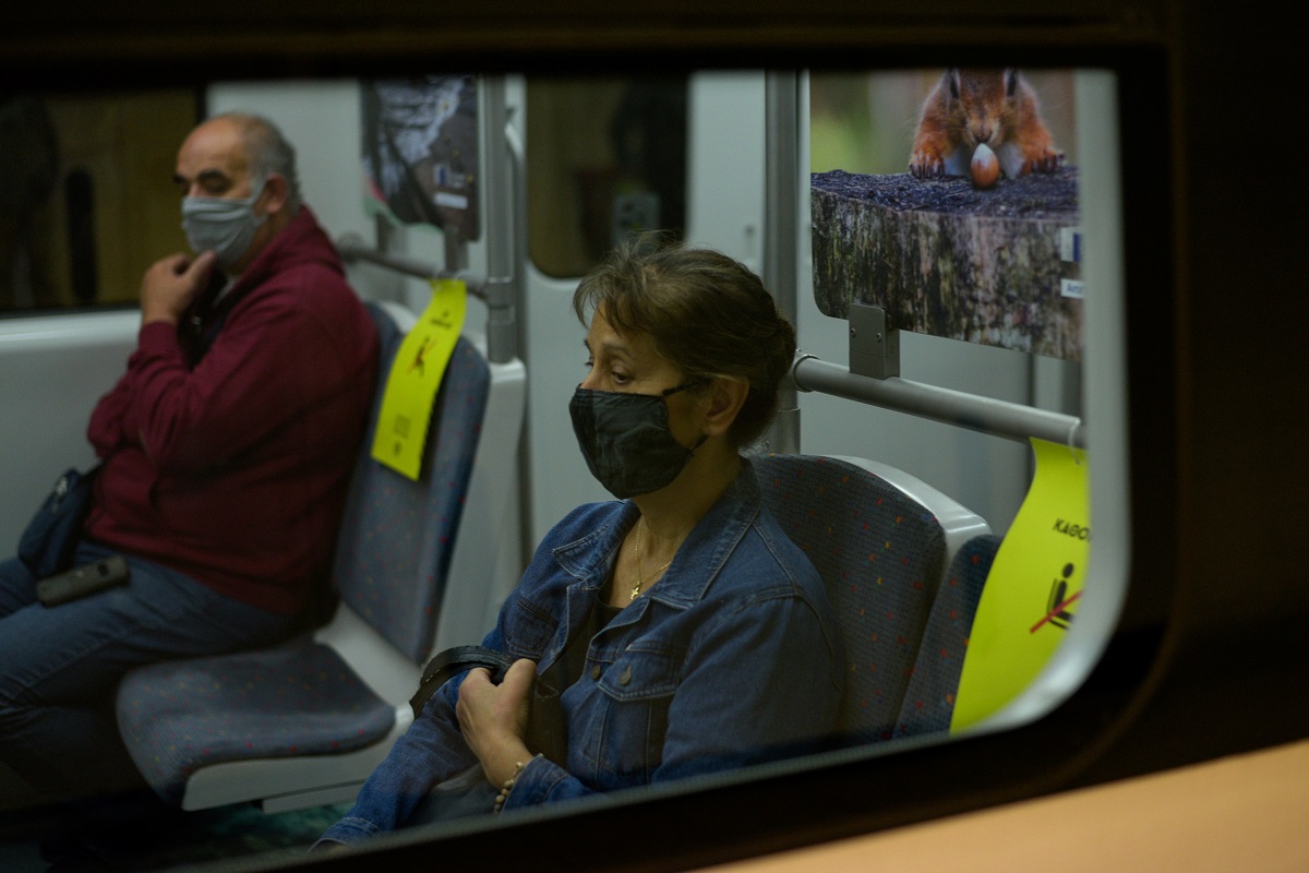 Commuters wearing protective face masks are seen on board a train, amid the spread of the coronavirus disease (COVID-19), in Athens