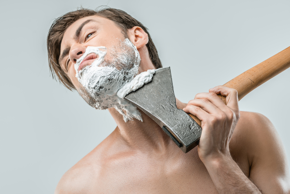 man shaving with ax