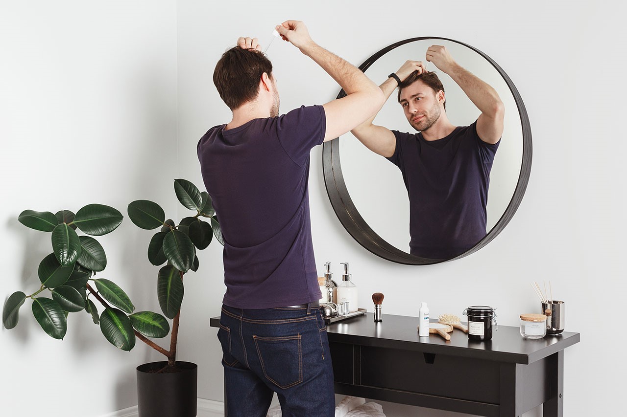 checking hair loss in mirror