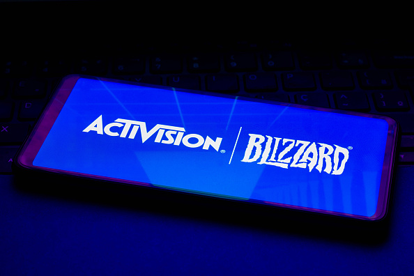 In this photo illustration, an Activision Blizzard logo is...