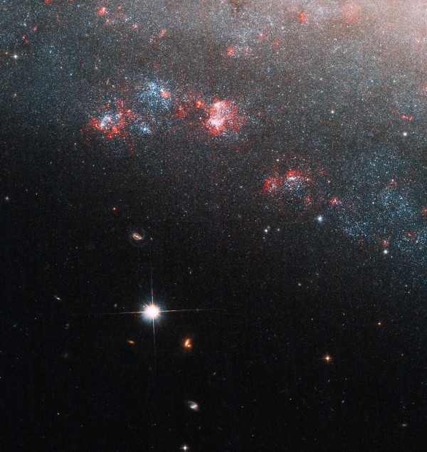 NASA’s Hubble Telescope Looks Into 'Needle's Eye' of Dwarf Spiral Galaxy With Strange Void