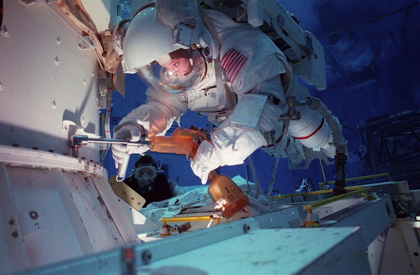 Astronaut Tamara E Jernigan Mission Specialist Uses A Special Tool During An Underwater Simulatio