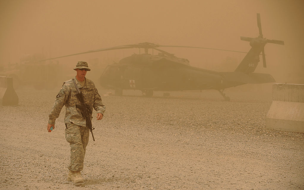 US army soldier walks past a US army Bla