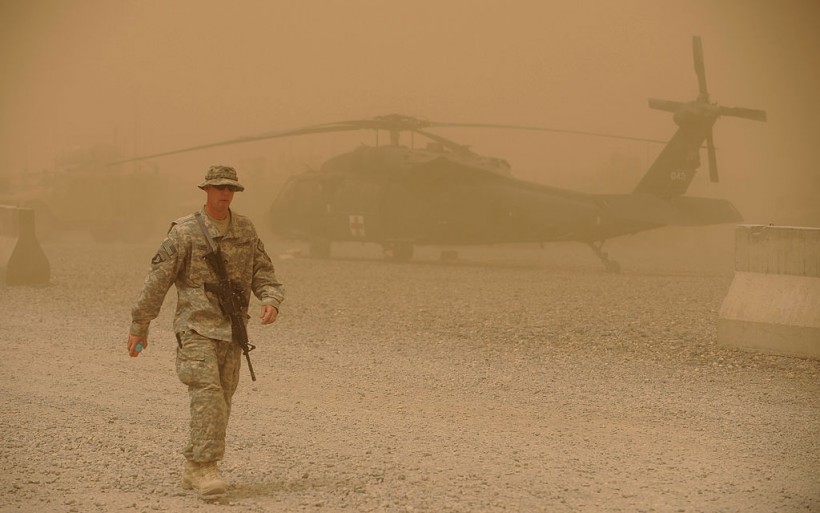 US army soldier walks past a US army Bla