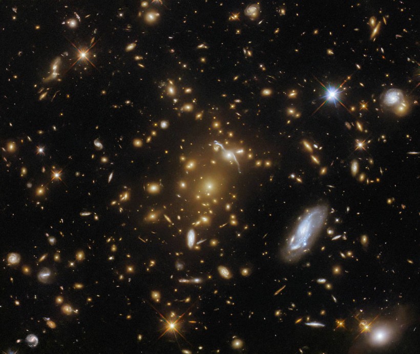 Hubble Captures a Light-Bending Galaxy Cluster