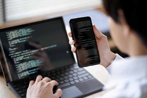 Asian programmer checking the operation of the code stock photo