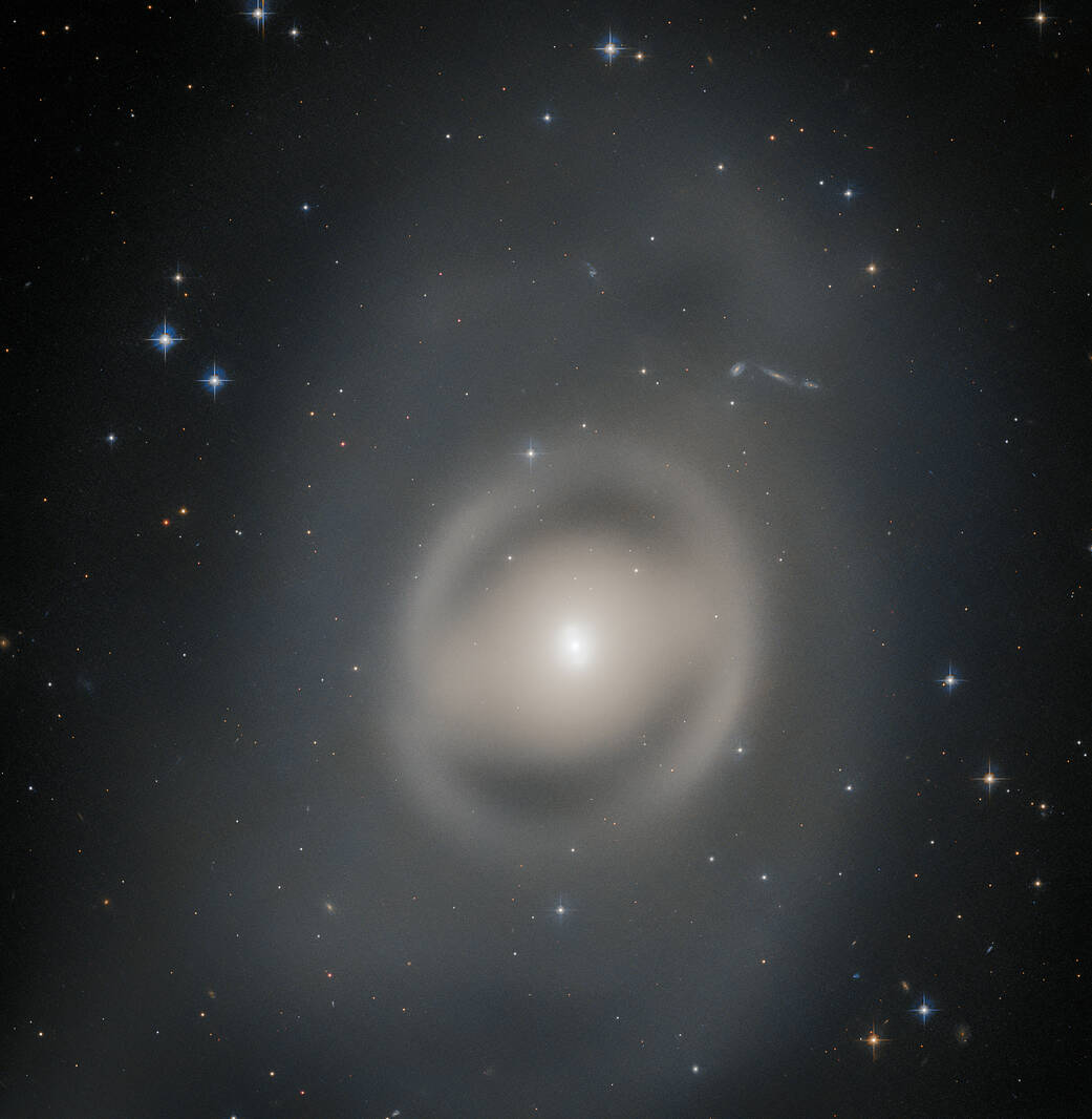 NASA's Hubble Space Telescope Captures a Lenticular Galaxy Bathing in Pale Ghostly Light