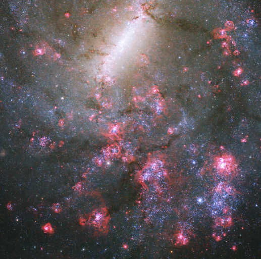 NASA's Hubble Space Telescope Catches Spiral Galaxy in Patches of Bright Pink, Dark Red