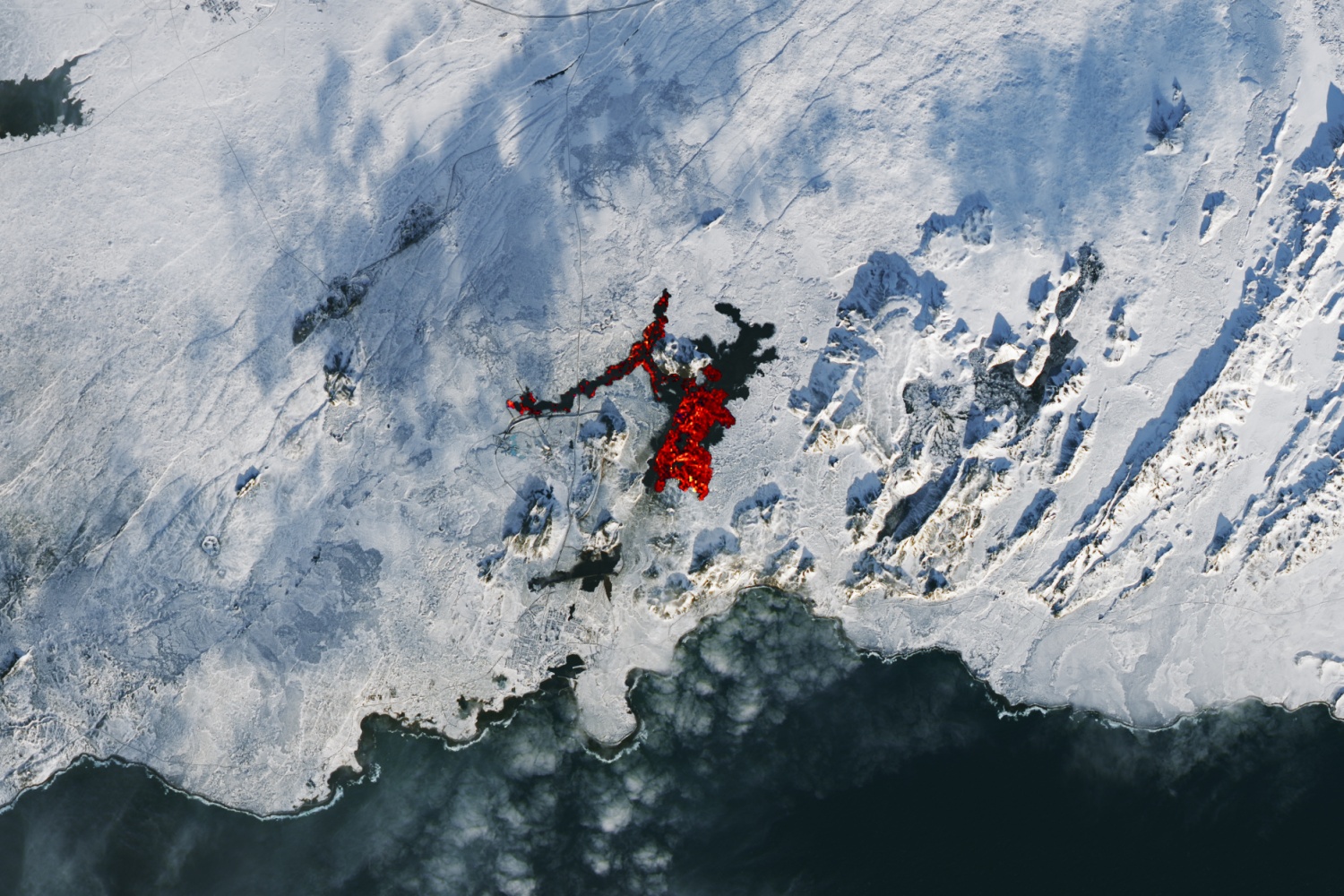 NASA Captures Bright Red Lava Eruption in the Snowy Expanse of Iceland